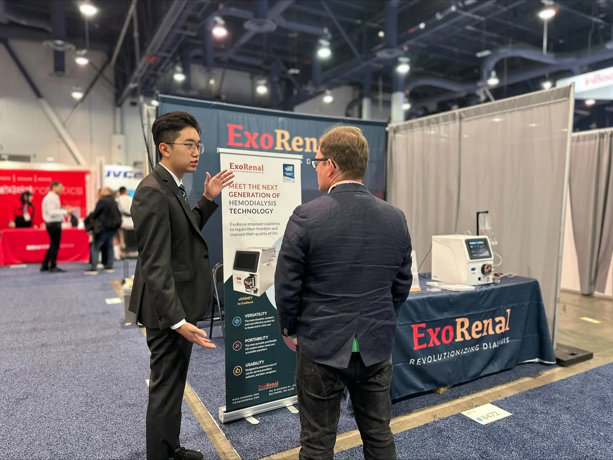 Our team walking a visitor through XKIDNEY at the Exorenal booth