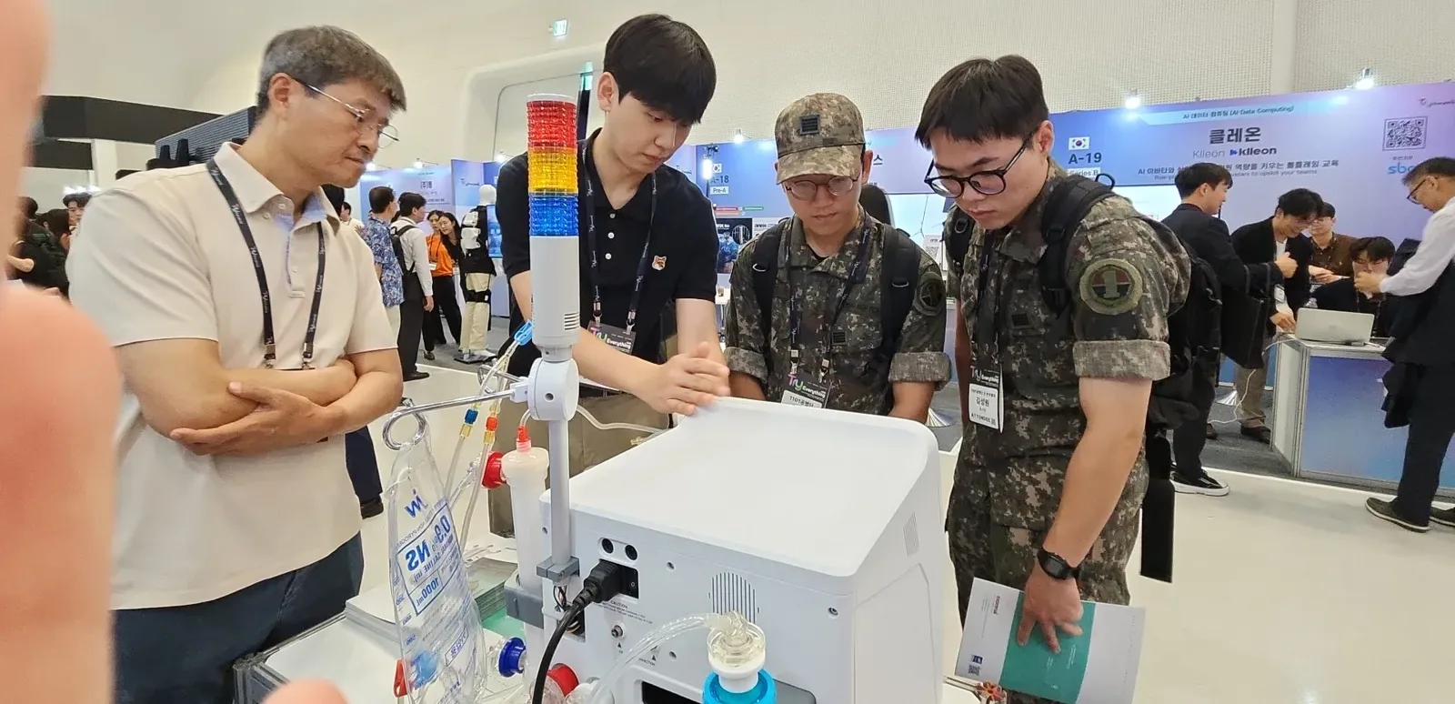 Visitors leaning in to look at the machine